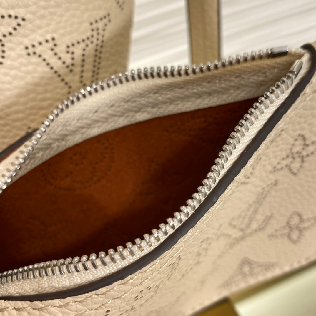 Louis Vuitton Luxury Cream Perforated Leather Tote Bag with Round Charm