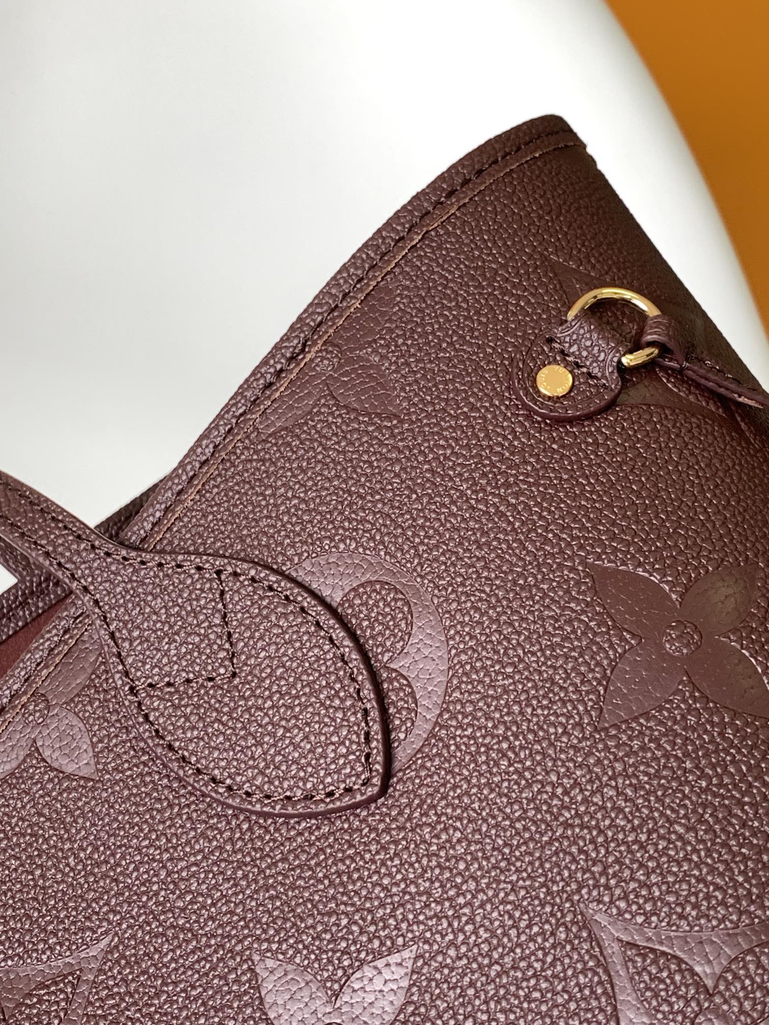 Louis Vuitton Elegant Burgundy Embossed Leather Tote Bag with Side Drawstrings