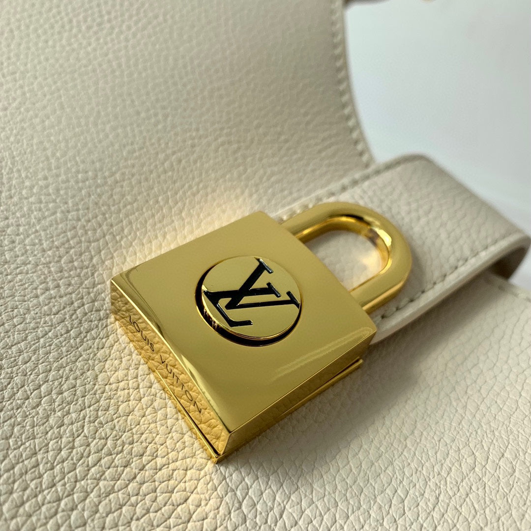 Elegant Cream Leather Crescent Shoulder Bag with Gold Padlock Detail